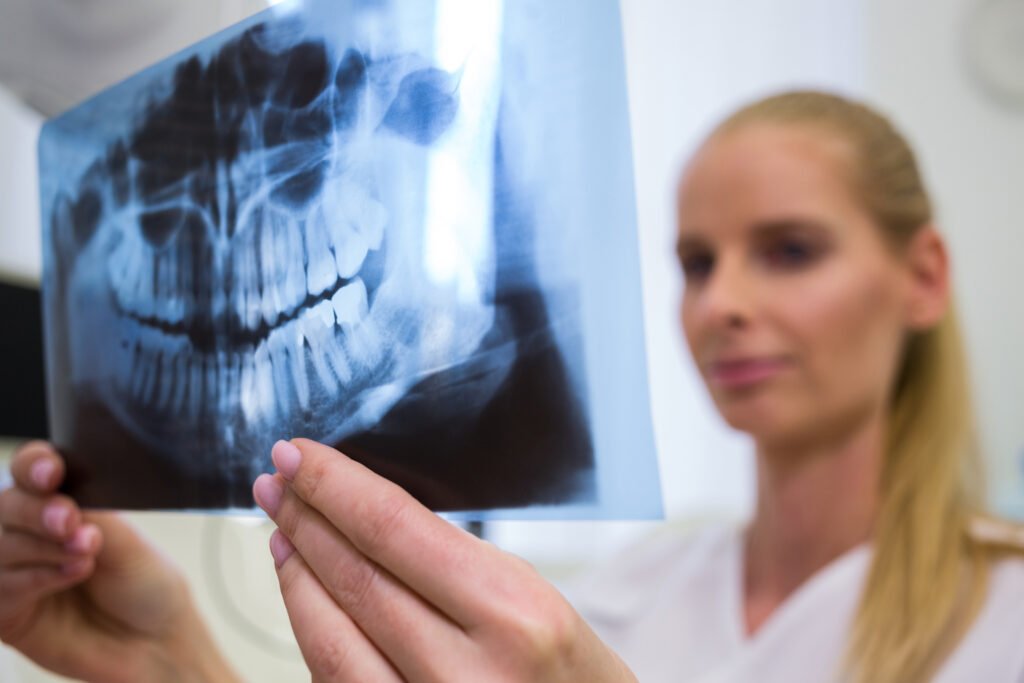 dentist looking dental x ray plate scaled
