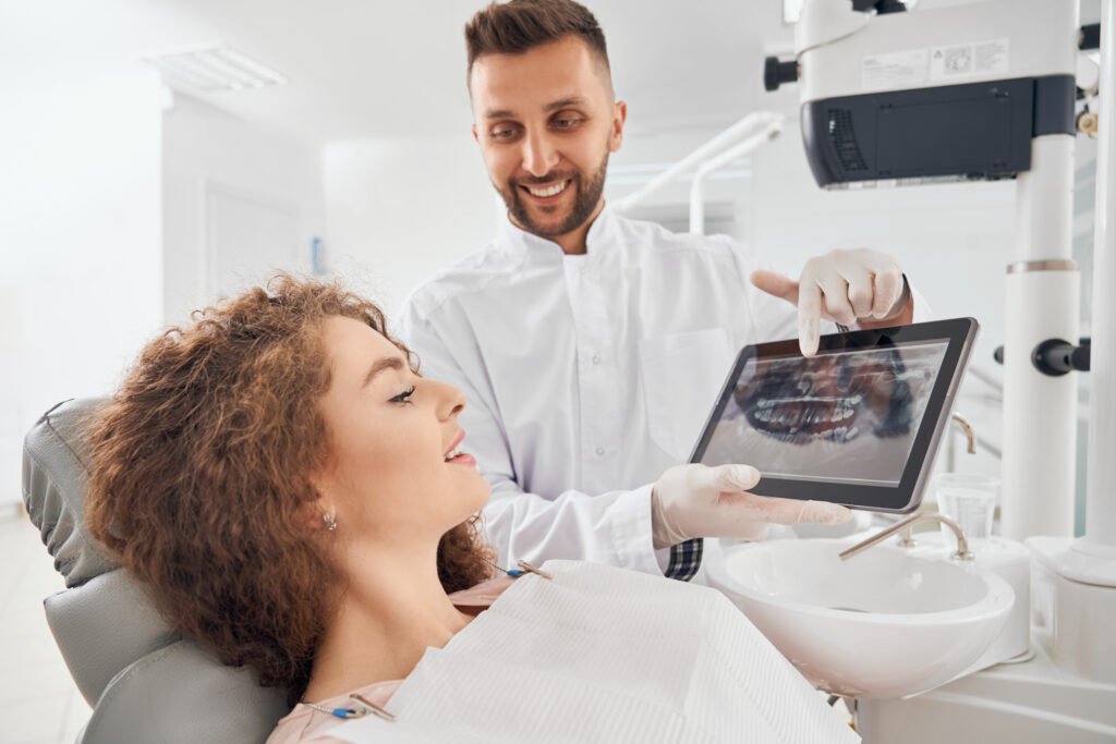 male doctor showing xray pictures teeth tablet scaled